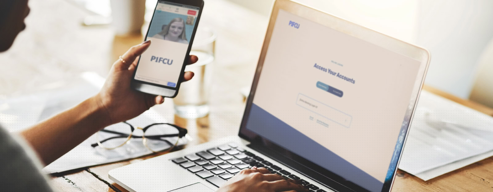 Person looking at P1FCU website on laptop and mobile device