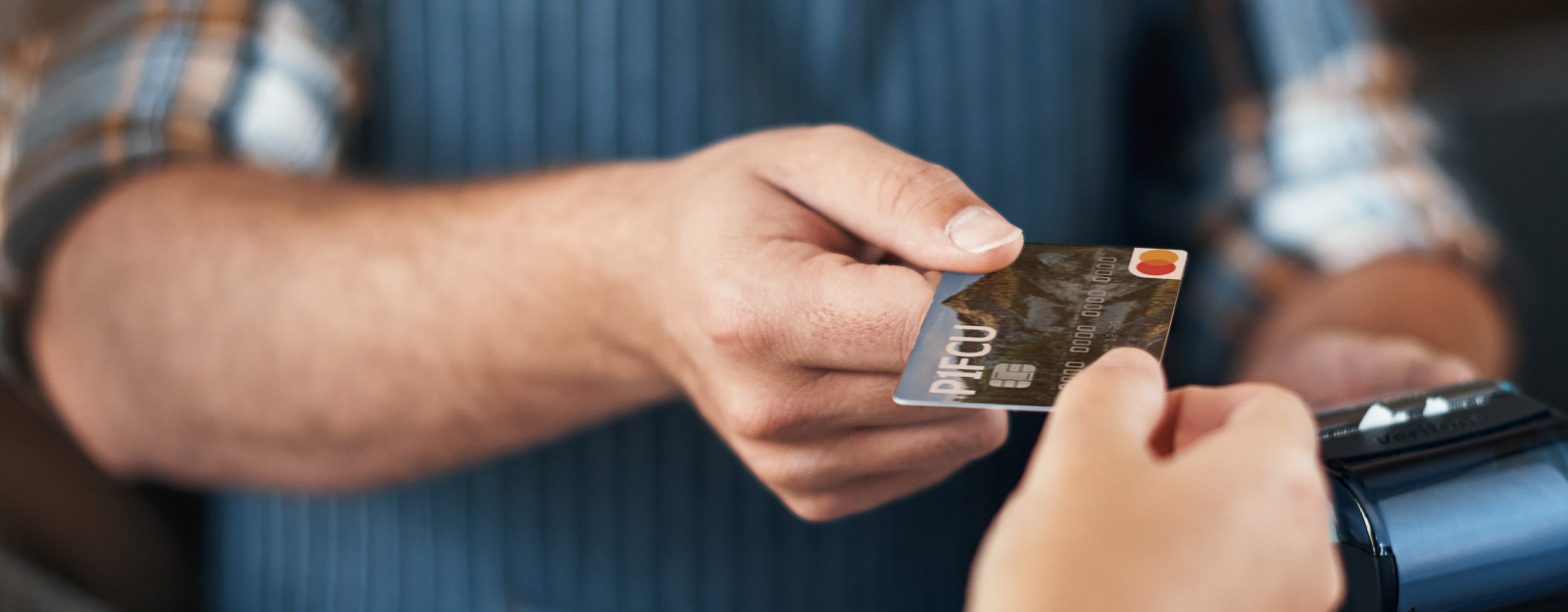 Person handing over P1FCU debit card