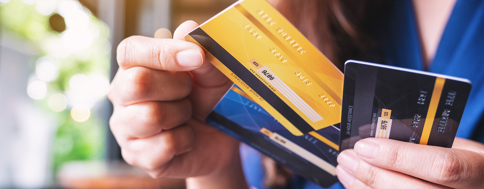 hand holding several credit cards