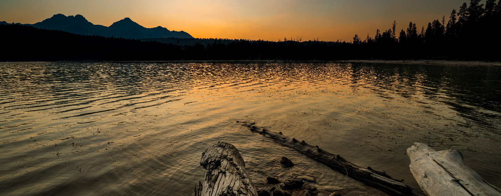 Sunset on water with mountains in the background