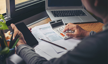 man with calculator and phone