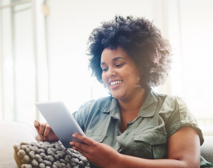Woman enjoying her experience on her tablet device.