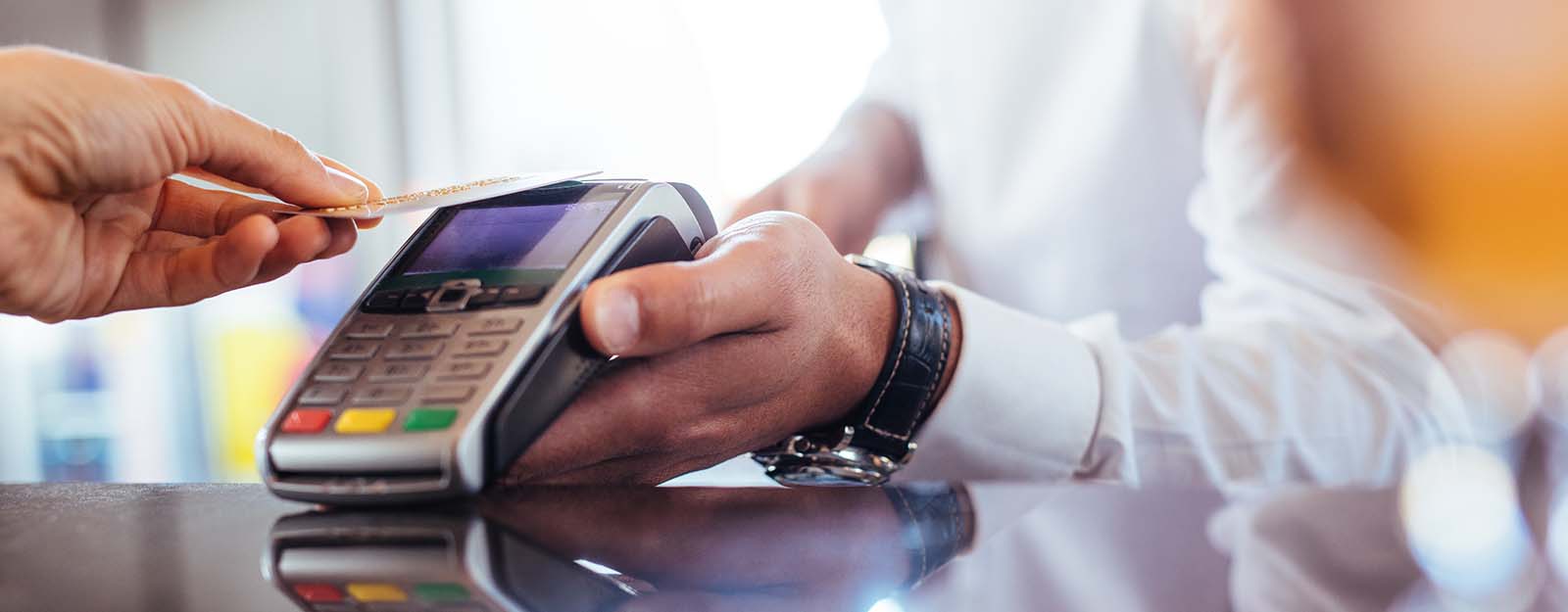 Person swiping card at merchant machine