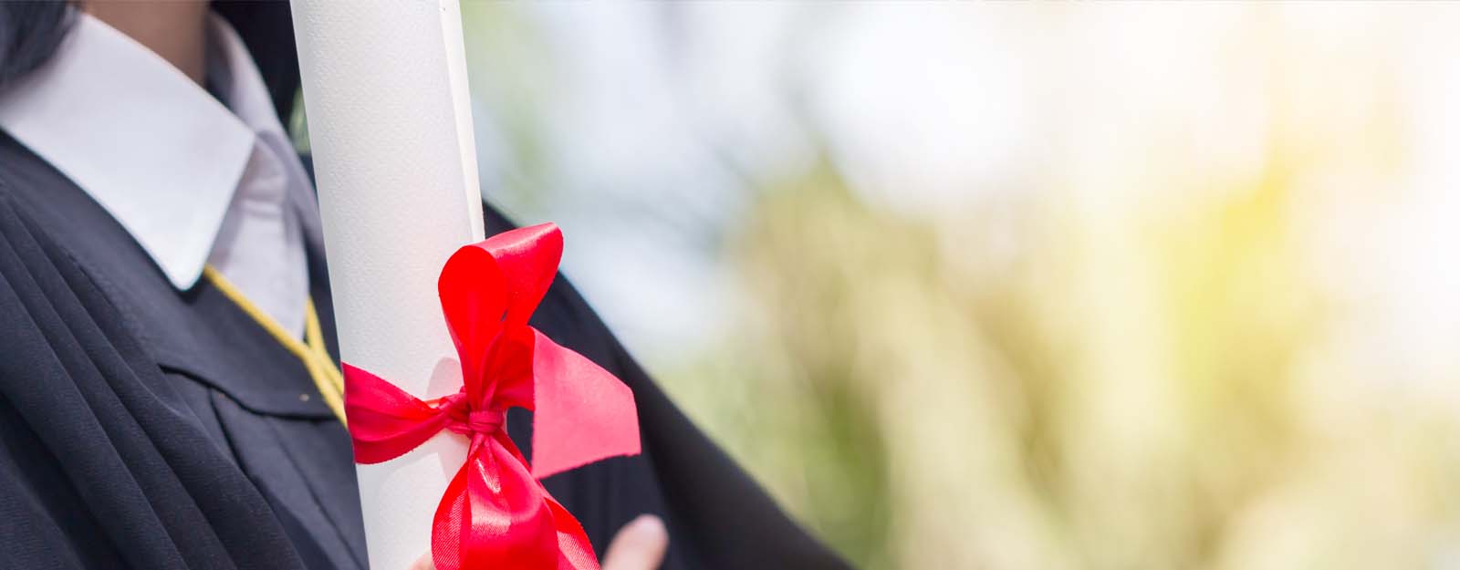 Person holding diploma in graduation gown