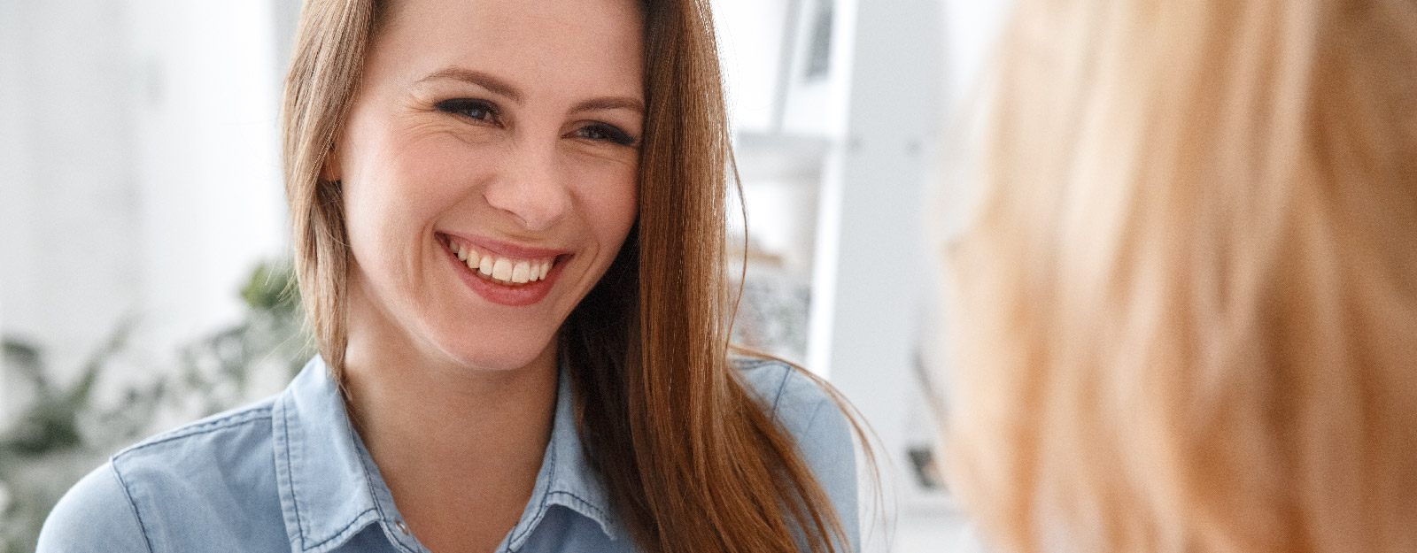 Happy woman gets advice from another woman.