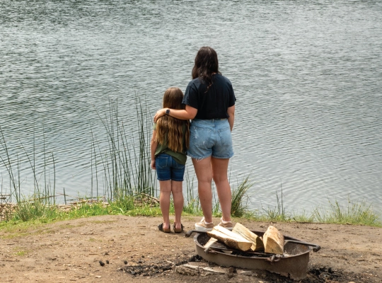 woman and child looking at lake