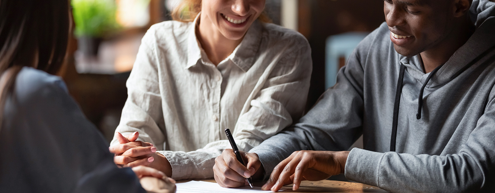 couple signs mortgage documents