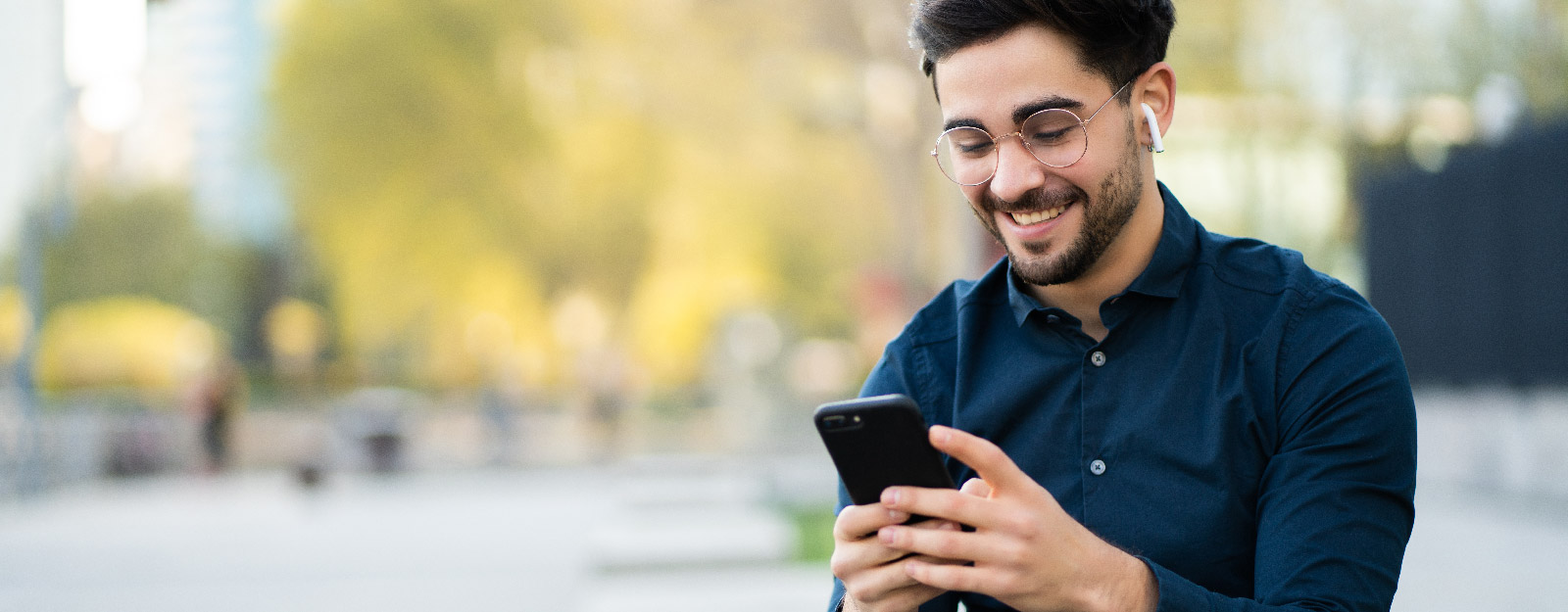 Man on smart phone in city