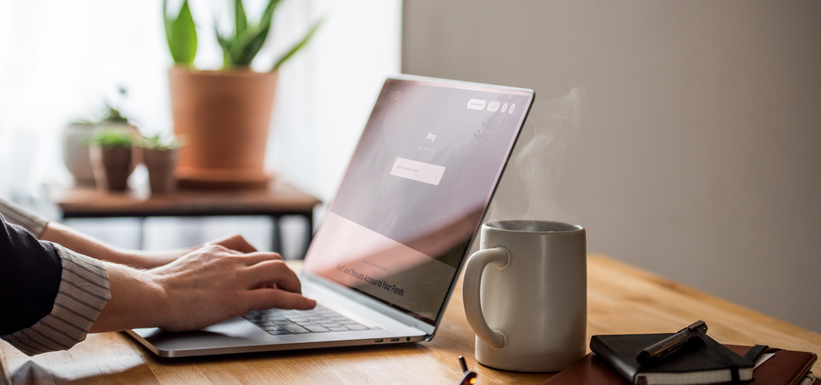 Woman at desk on P1FCU laptop