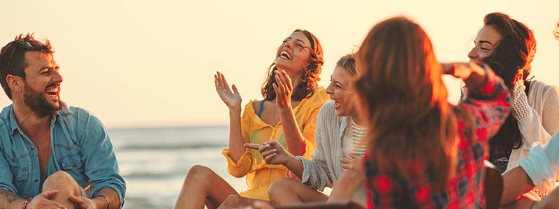 People on beach laughing together