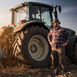 Tractor with man standing in front of it