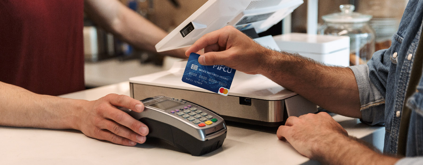 Person swiping P1FCU card in merchant machine