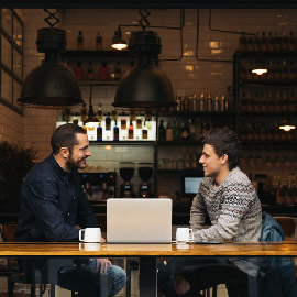 People talking at cafe and smiling