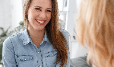 Happy woman gets advice from another woman.
